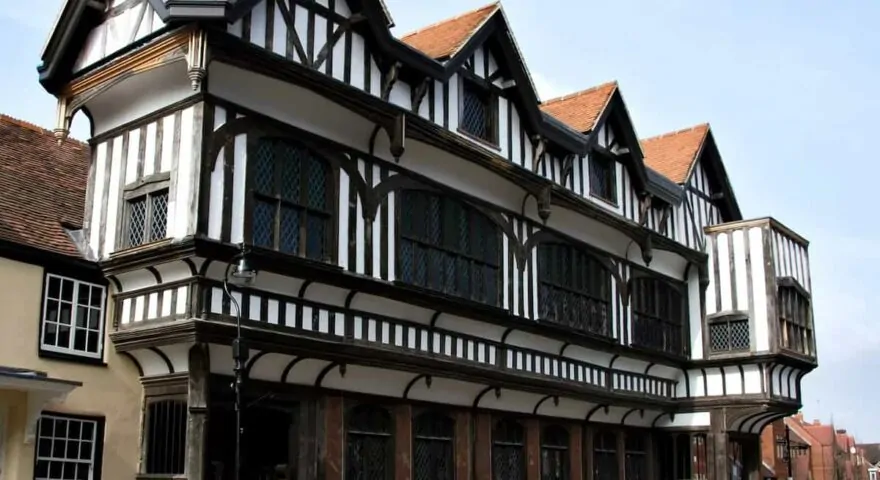 large tudor property on a street